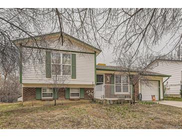Charming home with a brick facade and green trim, showcasing its inviting curb appeal and well-maintained exterior at 2108 S Idalia S St, Aurora, CO 80013
