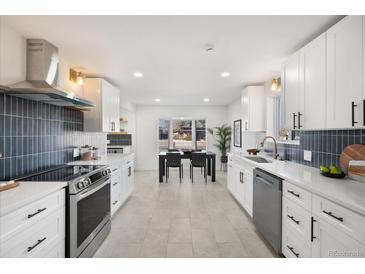 Bright kitchen with white cabinets, stainless steel appliances, and dining area with natural light at 3070 N Glencoe St, Denver, CO 80207
