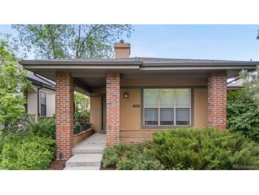 Inviting front exterior featuring a covered porch and manicured landscaping around the home at 1076 Rosemary St, Denver, CO 80230