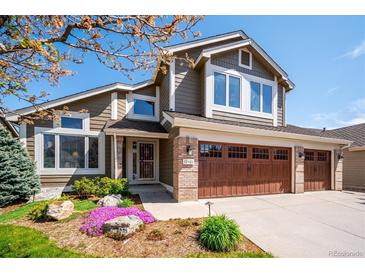 Beautiful two-story home featuring a three car garage and manicured lawn at 12421 W Fair Dr, Littleton, CO 80127