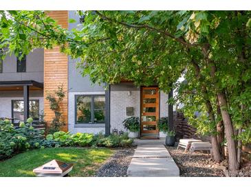 Contemporary two-story home featuring a wood door, xeriscape yard, and modern design at 3168 W 29Th Ave, Denver, CO 80211