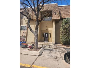 Attractive exterior view of a multi-Gathering unit with mature landscaping at 7695 E Quincy Ave # 201, Denver, CO 80237