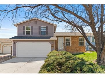 Charming two-story home features a two-car garage, brick accents and a well-maintained front yard at 3732 S Halifax St, Aurora, CO 80013
