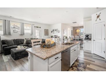 Open concept kitchen features granite countertops and stainless steel appliances at 24747 E Calhoun Pl # C, Aurora, CO 80016