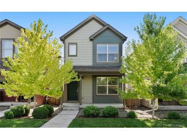 Charming two-story home with green and grey siding and a well-manicured front yard at 12777 Ulster St, Thornton, CO 80602