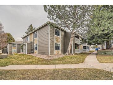 Attractive apartment building with stone accents and mature trees set in a well-maintained landscape at 18073 E Ohio Ave # 203, Aurora, CO 80017