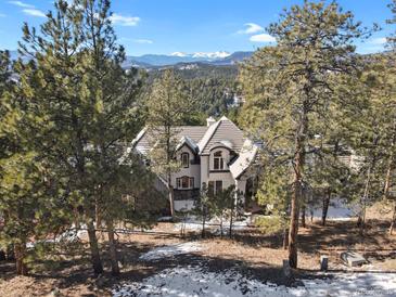 Luxury home nestled in a mountain setting with stunning views at 25220 Montane Dr, Golden, CO 80401