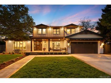 Stunning two-story home with a well-manicured lawn, inviting entrance, and attached garage at 5810 S Galena St, Greenwood Village, CO 80111