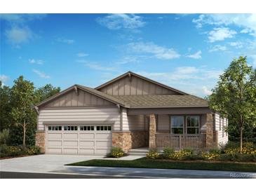 Charming single-Gathering home showcasing stone accents, a front porch, an attached garage, and manicured landscaping at 20665 E 57Th Dr, Aurora, CO 80019