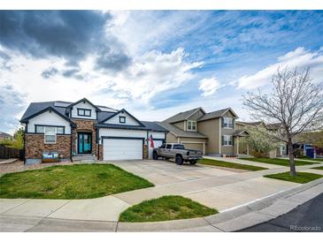 Charming two-story home featuring a well-manicured lawn and a driveway with ample parking space at 11699 Pink Phlox Dr, Parker, CO 80134