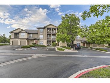 Inviting condo building with well-maintained landscaping and ample parking on a beautiful day at 7418 S Quail Cir, Littleton, CO 80127