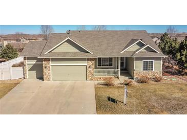 Charming single-Gathering home with stone accents, a two car garage and a well-manicured front yard at 9912 Bradbury St, Firestone, CO 80504