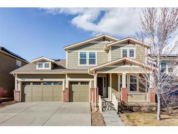 Charming two-story home features a three-car garage, a covered porch, and well-maintained landscaping at 19503 W 58Th Pl, Golden, CO 80403