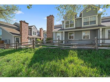 Charming townhomes featuring well-maintained lawns and classic brick chimneys offer a welcoming curb appeal at 8329 W 90Th Pl, Westminster, CO 80021