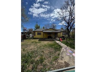 Charming single-story home with a spacious front yard and a welcoming porch at 1395 Havana St, Aurora, CO 80010
