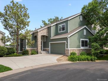Charming two-story home with stone accents, attached garage, and a well-manicured front yard at 7400 W Grant Ranch Blvd # 19, Littleton, CO 80123