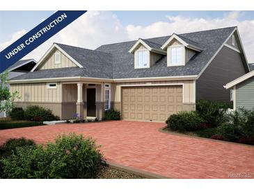 Charming home featuring a brick driveway, two-car garage, dormer windows, and neutral color palette at 21905 E 51St Dr, Aurora, CO 80019
