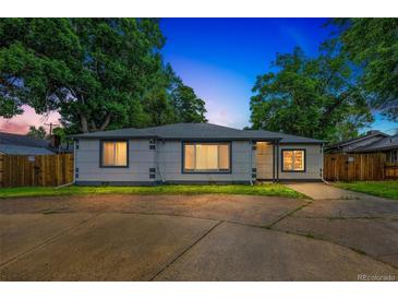 Charming single story home with mature trees and a large driveway at 7010 W 44Th Ave, Wheat Ridge, CO 80033