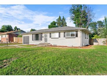 Charming single-story home with a well-maintained lawn, garage, and a classic design at 2996 S Sheridan Blvd, Denver, CO 80227