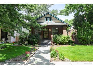 Charming brick home with a well-manicured front yard and inviting walkway at 321 S Gilpin St, Denver, CO 80209