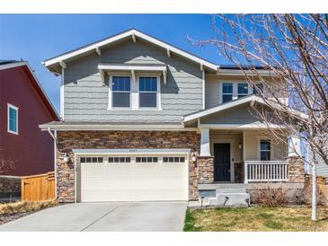 Charming two-story home with a stone facade and attached two-car garage in a suburban neighborhood at 5957 N Orleans St, Aurora, CO 80019