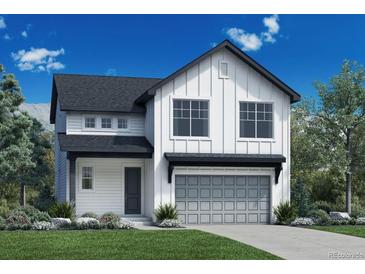 Charming two-story home featuring a two-car garage, well-manicured lawn, and classic architectural design at 475 Welded Tuff Trl, Castle Rock, CO 80104