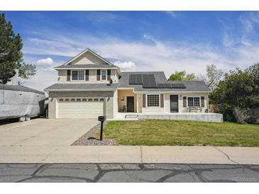 Charming two-story home with a manicured lawn and a two-car attached garage at 9908 Garfield Ct, Thornton, CO 80229