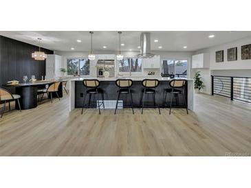 Modern kitchen features large island with bar seating and pendant lighting at 10508 W Chautauga Mtn, Littleton, CO 80127