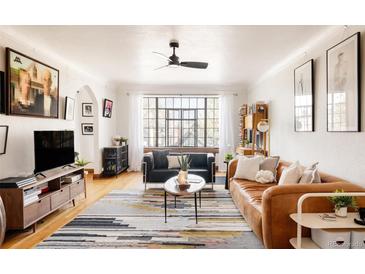 Bright living room with large window, modern furniture, and stylish decor at 1060 N Washington St # 301, Denver, CO 80203