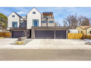 Modern home showcasing a three-car garage with a sleek design and well-maintained landscaping at 3910 Reed St, Wheat Ridge, CO 80033