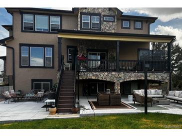Spacious home featuring a patio and deck for outdoor entertaining and relaxation at 6985 Fallon Cir, Castle Rock, CO 80104