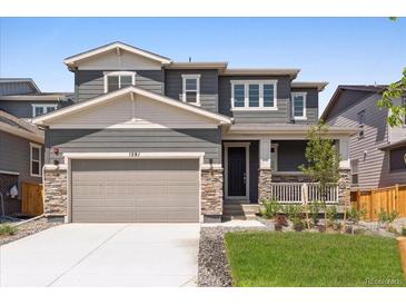 Charming two-story home featuring stone accents, a covered front porch, a well-maintained lawn and two car garage at 1281 Loraine N Cir, Lafayette, CO 80026