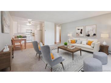 Inviting living room with neutral tones and stylish furnishings adjacent to the bright kitchen at 655 S Alton Way # 5C, Denver, CO 80247