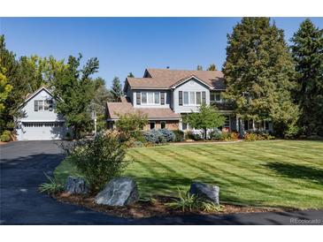 Stunning two-story home boasting lush lawns, mature trees, and an elegant exterior at 4483 W Cottonwood Pl, Littleton, CO 80123