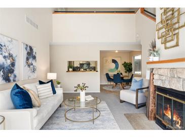 Bright living room features a fireplace, comfortable seating, and decor at 3600 S Pierce St # 7-201, Denver, CO 80235