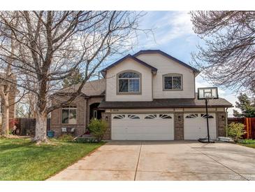 Charming two-story home featuring a three-car garage, manicured lawn and traditional design at 9754 Las Colinas Dr, Lone Tree, CO 80124