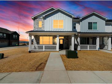Charming two-story home featuring stone accents, white siding, and a welcoming front porch at 6531 N Malaya St, Aurora, CO 80019