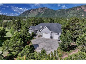 Stunning home featuring a three-car garage, large driveway, and mountain views at 18376 Heavens Pl, Monument, CO 80132