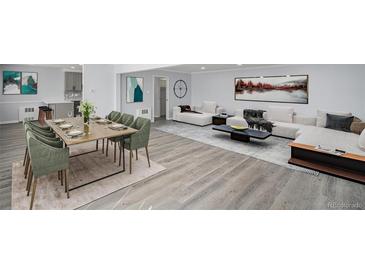 Bright open-concept living and dining area with modern decor and stylish, updated finishes at 2203 S Holly St # 3, Denver, CO 80222