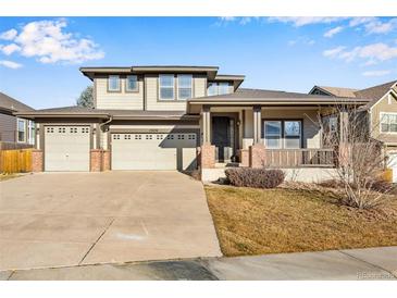 Two-story house with attached two-car garage and landscaped front yard at 13676 Cherry Way, Thornton, CO 80602