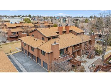 Aerial view of a brown multi-unit building with surrounding landscape at 540 S Forest St # 7-102, Denver, CO 80246