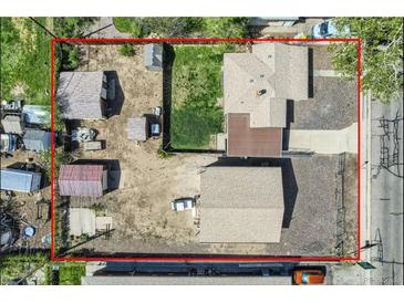 Aerial view of a property with a fenced yard, several outbuildings, and a detached garage at 4835 Harlan St, Wheat Ridge, CO 80033