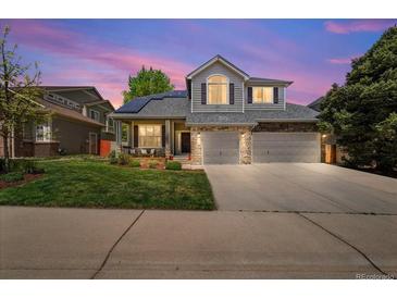 Charming two-story home featuring a stone facade, well-manicured lawn, and a spacious two-car garage at 2019 Clipper Dr, Lafayette, CO 80026