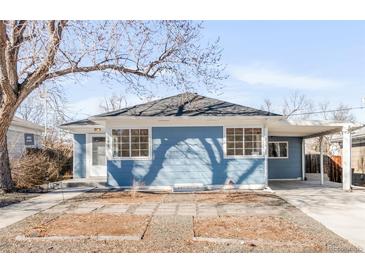 Charming blue home featuring large windows, a carport and a well-maintained front yard at 1825 S Adams St, Denver, CO 80210