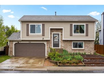 Charming two-story home with a brick facade and a well-maintained front yard in a suburban neighborhood at 3312 Meadow Ave, Broomfield, CO 80020