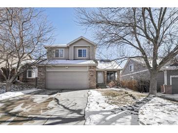 Charming two-story home with a two-car garage, and a well-maintained front yard at 19844 E Vassar Ave, Aurora, CO 80013