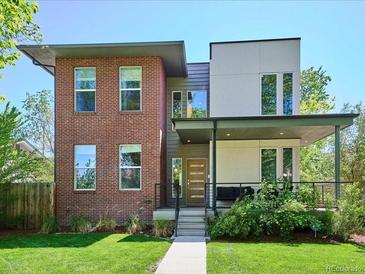 Modern two-story home with a mix of brick and siding, complemented by a well-manicured lawn at 2508 S Pennsylvania St, Denver, CO 80210