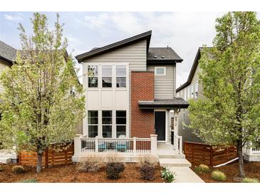 Charming two-story home with a modern design, landscaped yard, and inviting front porch at 8917 Yates Dr, Westminster, CO 80031