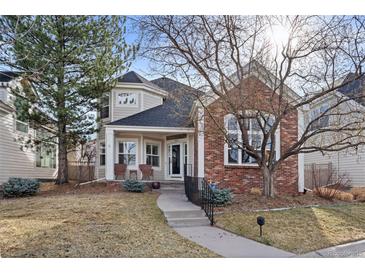 Charming two-story home with brick accents, a welcoming front porch and mature trees in a well-kept lawn at 1011 S Valentia St # 121, Denver, CO 80247