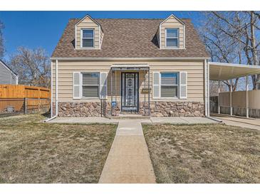 Charming home featuring stone accents and a covered carport for convenient parking at 1805 W Stoll Pl, Denver, CO 80221